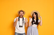 © New Africa - Tourism. Emotional couple in hats with camera on yellow background