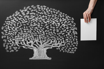 Wall Mural - Woman holding blank paper sheet over chalkboard with tree drawing, closeup