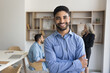 © fizkes - Portrait of smiling Arabian male employee, team leader, staff member dressed in shirt posing in workspace with arms-crossed look at camera, exudes confidence, competence in professional business field