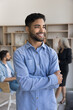 © fizkes - Business vision, opportunities, aspirations. Young man employee standing in office looking into distance with optimistic smile, feel satisfied with promotion, career in company and professional growth