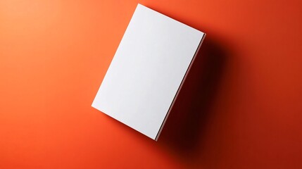 Aufkleber - Blank white book resting on vibrant orange background