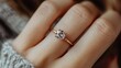 © ABIDZAR ALFAREZ - Close-up of a woman's hand wearing a solitaire diamond ring on her ring finger.
