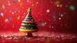 © thenort - Festive colorful toy Christmas tree with confetti on red background.