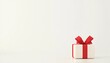© ZTA - A beautifully wrapped gift box with a red ribbon sits on a minimalist white background, evoking celebration