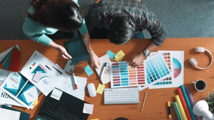 Sticker - Top down view of smart designer helping manager choosing color from colored palettes. Aerial view of businessman working together and planning together while looking at logo from laptop. Symposium.