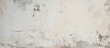 © meristock - Aged white wall with weathered grungy texture showing peeling paint in soft gray and beige tones suitable for copy space with minimal distractions.