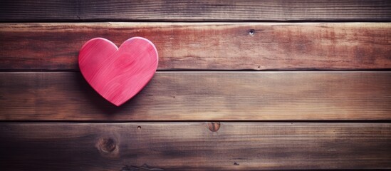 Poster - Vintage wooden background featuring a prominent red heart positioned on the left with ample copy space to the right, highlighting a romantic theme.