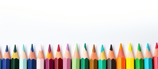 Aufkleber - Vibrant colored pencils arranged in a straight line on a white background showcasing shades of blue, green, yellow, and red for artistic inspiration