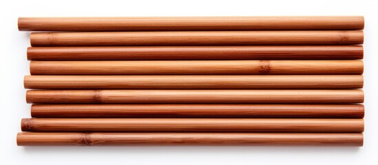 Leinwandbilder - Rustic wooden sticks arranged in parallel, featuring warm brown tones, against a clean white background, emphasizing natural textures and shapes.