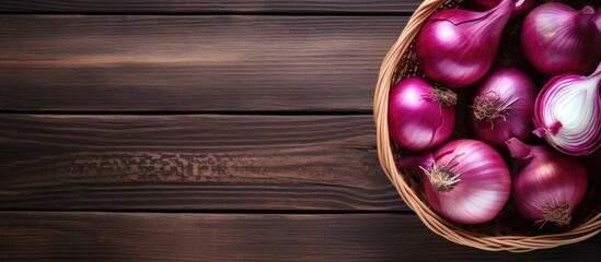 Poster - Basket filled with whole and sliced red onions on a dark wooden background with ample copy space to the right for text or graphics.