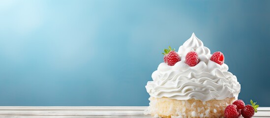 Poster - Fluffy vanilla cupcake topped with whipped cream and fresh strawberries on a wooden surface against a soft blue background creating a festive atmosphere