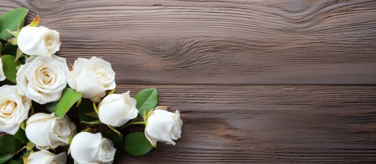 Poster - Delicate white field roses arranged on the left of a warm wooden surface with soft green leaves creating a serene floral backdrop.