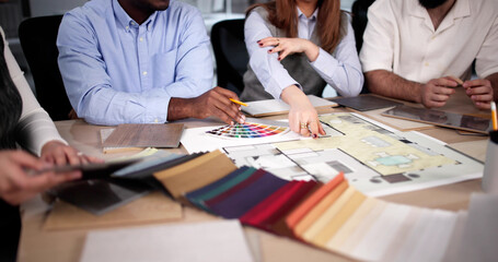 Poster - Designer Group At Desk Discussing Custom House