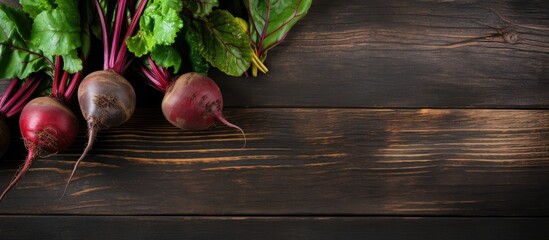 Poster - Close up of organic beetroots with vibrant greens on dark rustic wooden table background, showcasing rich red and earthy tones with ample copy space.
