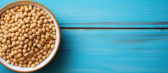 Poster - Bowl of soybeans positioned on the left side of a vibrant blue table with ample negative space for additional graphics or images.