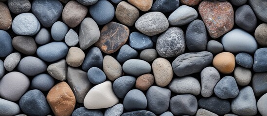 Leinwandbilder - Textured stones in varying shades of gray and brown create a close-up background with smooth surfaces arranged horizontally for a serene and natural look.