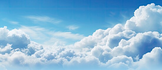 Poster - Vibrant blue sky with fluffy white clouds in the center and upper portion, creating a serene and expansive atmosphere ideal for backgrounds.