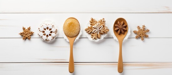 Poster - Warm wooden spoons with honey and decorated cookies in snowflake shapes on a white wooden table, creating a festive and cozy winter scene.