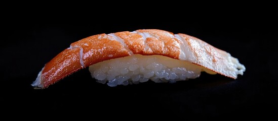 Poster - Succulent sushi piece with orange topping on white rice against a stark black background highlighting culinary elegance and freshness of seafood delights
