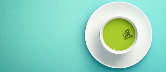 Aufkleber - Vibrant green pea soup in a white bowl on a smooth teal background highlighting the inviting color contrast and fresh appeal of the dish