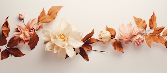 Poster - Elegant autumn floral arrangement featuring soft beige flowers and rich brown leaves on a light background, positioned horizontally for a serene effect.