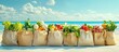 © Nijat - Grocery bags filled with fresh vegetables in cream tones lined up on sandy beach against clear blue sky and ocean waves promoting healthy living