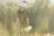 © Cavan Images - Lone biker enjoys a sunset ride on a gravel road in the countryside.