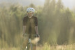 © Cavan Images - Cyclist riding a dirt trail surrounded by nature in a quiet rural area