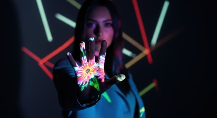 Wall Mural - Young caucasian female with floral hand projection in colorful light