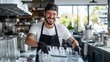 © Marta P. (Milacroft) - Smiling dishwasher arranging clean glasses in restaurant kitchen