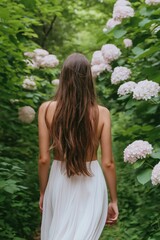 Canvas Print - A woman walks through a forest with pink flowers. The flowers are in full bloom and the woman's hair is wet. The scene is serene and peaceful