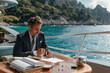 © Александр Марченко - Businessman working on luxury yacht near capri island