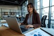 © Ace64 Studio - Young businesswoman professional employee using pc doing online banking analysing at workplace. Latin hispanic middle age business woman working on laptop computer in modern office.