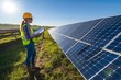 © YURIMA - On a sunny day, a female engineer in a hard hat and safety vest inspects solar panels at a renewable energy farm to enhance their performance and boost efficiency in generating clean electricity