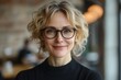 © c80 - Cheerful woman with glasses smiles warmly in a cozy cafe setting during the afternoon