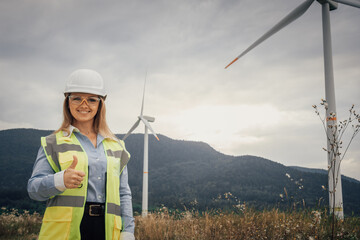 Poster - This confident female engineer is actively engaged at a wind farm, contributing to the development of renewable energy infrastructure that promotes sustainability and innovation in the industry