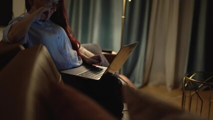 Aufkleber - A young person is engaged in online activities at home with a laptop, blending learning and entertainment in a cozy atmosphere enhanced by soft curtains, creating a relaxing environment