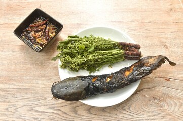 Wall Mural - grilled catfish and Siamese neem tree Indian vegetable on plate dipping with sweet and sour fish sauce