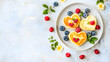 © Hammad - A romantic breakfast with heart-shaped pancakes topped with berries