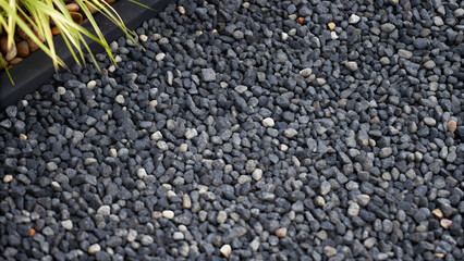 Wall Mural - Black gravel background with small pebbles, close-up view