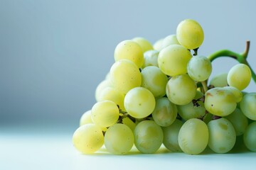Poster - close up of a bunch of ripe green grapes, showcasing their texture and freshness on a simple backgro