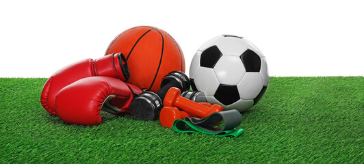 Wall Mural - Different sport equipment on green grass against white background