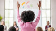 © Kowit - A woman in a pink shirt raises her hand in the air
