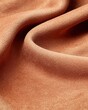 © xbzz - Extreme closeup of mocha mousse tone suede material warm brown surface soft texture refined aesthetic