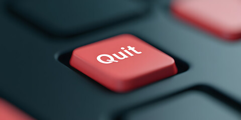 Close-up of a red button on a dark keyboard that says 'Quit'.  The image suggests the concept of making a decision, ending a process, or exiting something.