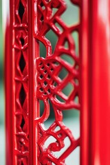 Poster - A detailed view of a bright red metal structure with sharp edges and rusty texture, perfect for industrial or mechanical themed designs