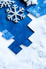 Sticker - Festive Winter Scene with Sparkling Snowflakes on a Blue and White Textured Background