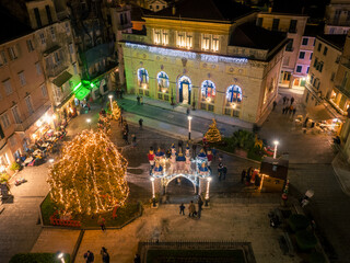 Wall Mural - Aerial view of Corfu Town, Greece, adorned with Christmas lights and decorations. The Liston, a historic arcade, is prominent, showcasing the festive atmosphere.