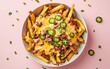 © Svitlana - Loaded fries bursting with cheddar, jalapeÃ?os, pastel pink background