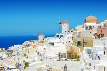 Wall Mural - Oia village on Santorini island, Greece. Traditional and famous houses and windmill over the Caldera, Cyclades islands Aegean sea.
